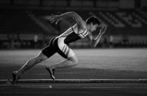 Sprinter leaving starting blocks on the running track